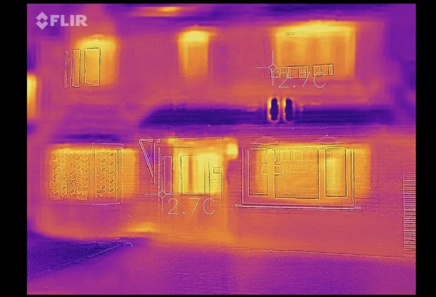Thermal camera scan during a North Texas home energy audit showing temperature differences across building envelope